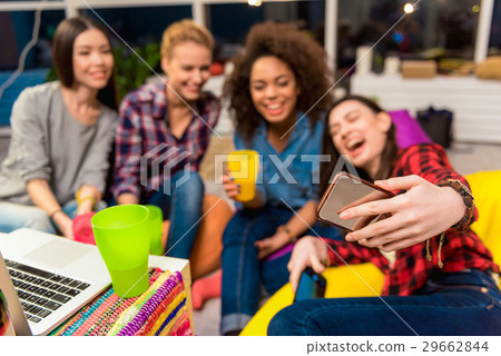 Beaming girls doing self-portrait photo 29662844