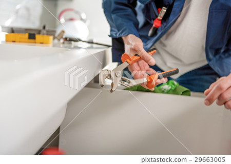 Man using tool for upkeep Man using tool for upkeep 29663005
