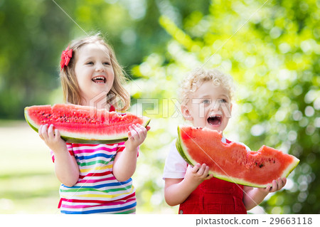 Kids eating watermelon in the garden Kids eating watermelon in the garden 29663118
