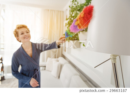Joyful woman cleaning room with broom 29663187