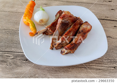 grilled barbecued spare ribs with baked beans  29663350