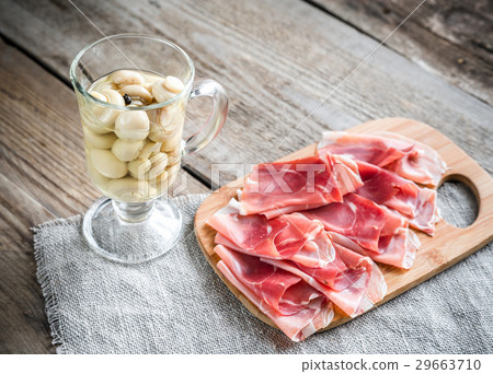 Slices of jamon on the wooden board Slices of jamon on the wooden board 29663710