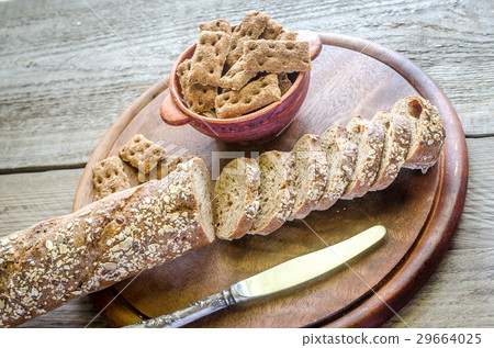 Baguette with crisps on the wooden tray Baguette with crisps on the wooden tray 29664025