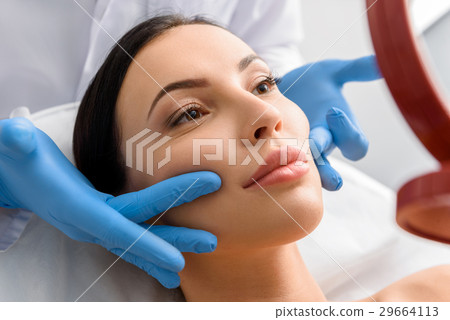 Physician removing wrinkles of lady Physician removing wrinkles of lady 29664113