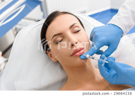 Calm girl getting cosmetic procedure Calm girl getting cosmetic procedure 29664138