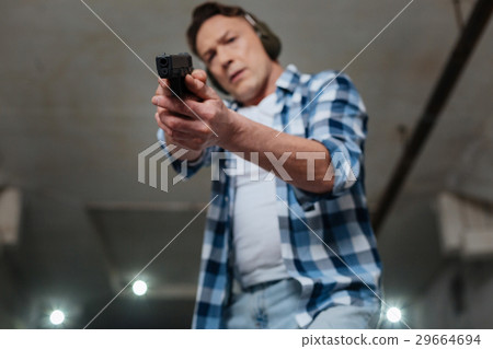 Selective focus of a handgun being in use Selective focus of a handgun being in use 29664694