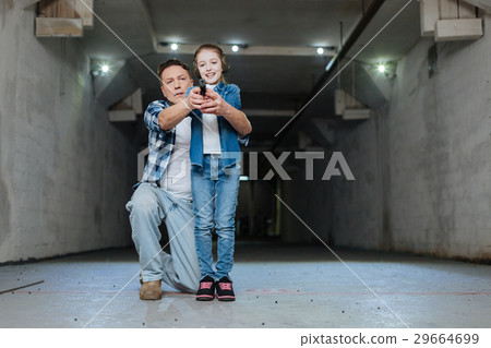 Serious pleasant man sitting on one knee 29664699