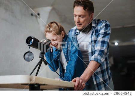 Delighted cheerful girl spending time with his 29664842