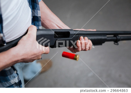 Red riffle bullet dropping out of the gun 29664863