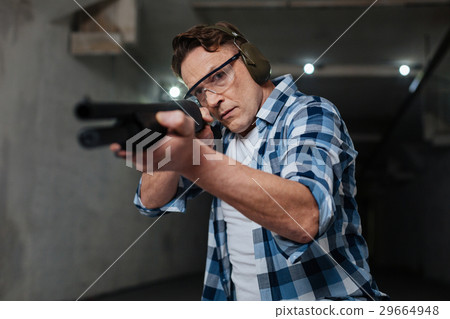 Confident skilled shooter pulling the trigger 29664948