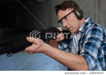 Confident skilled marksman concentrating on the 29664954