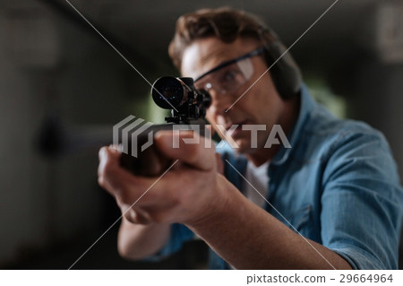 Handsome professional sniper looking into the 29664964
