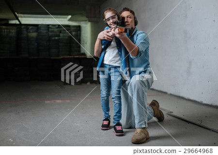 Positive delighted girl enjoying shooting 29664968