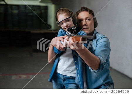 Cheerful positive girl trying to shoot Cheerful positive girl trying to shoot 29664969