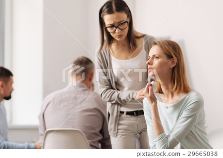 Worried secretary standing near her colleague 29665038