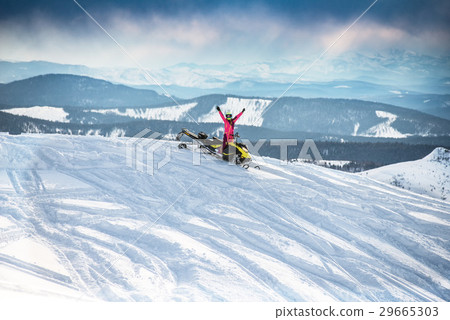 Rider on the snowmobile in the mountains Rider on the snowmobile in the mountains 29665303