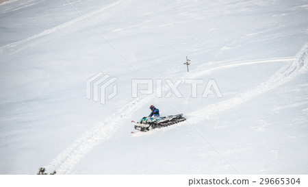 Rider on the snowmobile in the mountains . the Rider on the snowmobile in the mountains . the 29665304