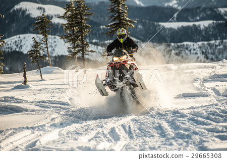 Rider on the snowmobile in the mountains. active Rider on the snowmobile in the mountains. active 29665308
