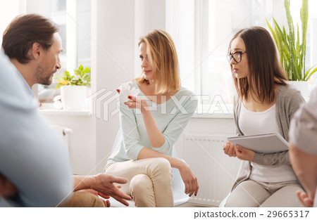 Two females looking at their colleague Two females looking at their colleague 29665317