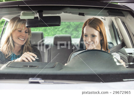 Teenager in car with driving instructor Teenager in car with driving instructor 29672965