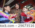 Asian family in front of store 29673516