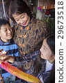 Asian family in front of store 29673518