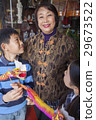 Asian family in front of store 29673522
