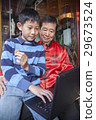 Asian family in front of store 29673524