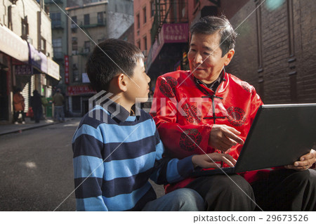 Asian family in front of store 29673526
