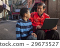 Asian family in front of store 29673527