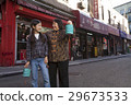 Asian family in front of store 29673533