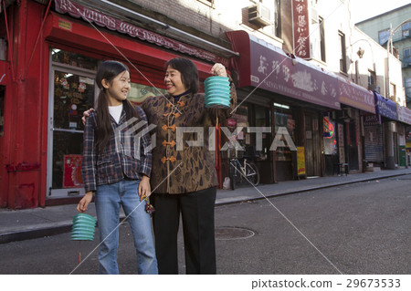 Asian family in front of store 29673533