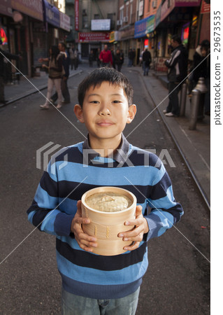 Boy holding dumplings 29673535