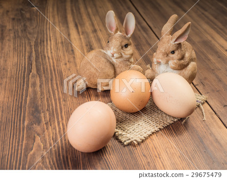 Easter bunnies on the background of wooden table Easter bunnies on the background of wooden table 29675479