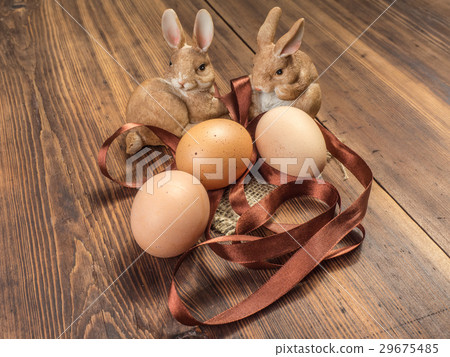Easter bunnies on the background of wooden table Easter bunnies on the background of wooden table 29675485
