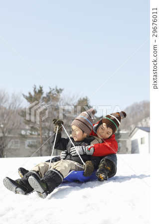 Children playing with sled 29676011