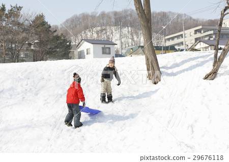 Children playing with sled Children playing with sled 29676118