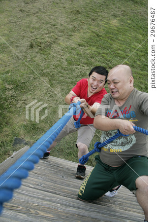 Men climbing playground equipment Men climbing playground equipment 29676487
