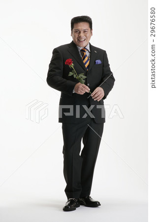 A man in a suit with rose flowers 29676580