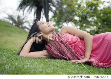 A young woman lying on the lawn A young woman lying on the lawn 29676854