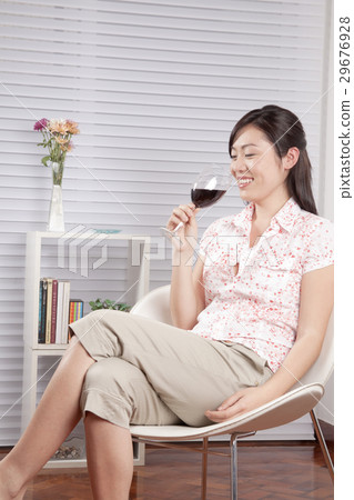 A young woman drinking red wine 29676928