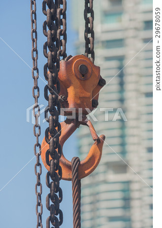 Orange hook hanging on a chain. Orange hook hanging on a chain. 29678059