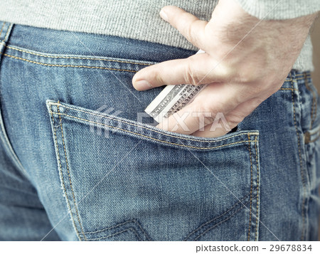 hand put dollars in jeans pocket hand put dollars in jeans pocket 29678834