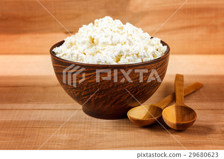 Fresh cottage cheese in bowl on a wooden Fresh cottage cheese in bowl on a wooden 29680623