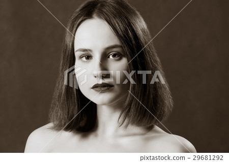 Portrait of a cute beautiful brunette looking at the camera Portrait of a cute beautiful brunette looking at the camera 29681292
