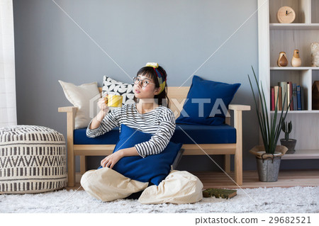 A woman relaxing in a Scandinavian girls room 29682521