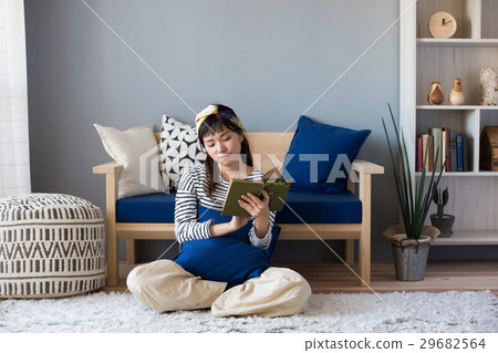 A woman reading a Scandinavian girls book 29682564