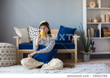 A woman relaxing in a Scandinavian girls room 29682568