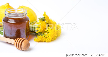 Dandelion honey in a jar and fresh flowers Dandelion honey in a jar and fresh flowers 29683703