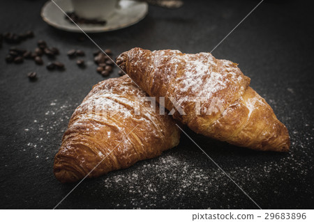 Croissant with sugar and coffee 29683896
